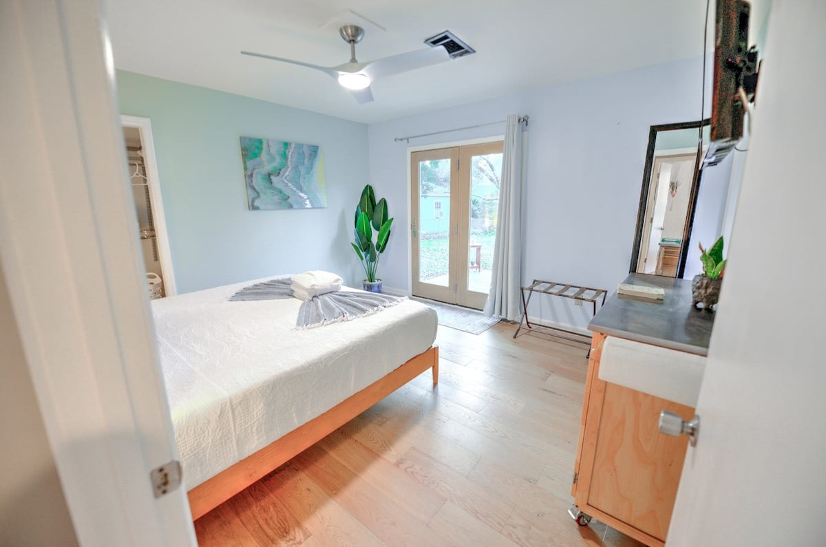 Bright bedroom with a large bed and glass doors