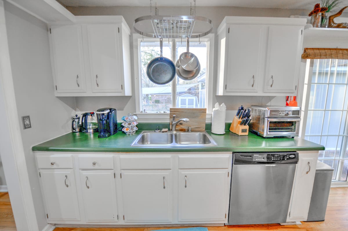 Kitchen sink wall with coffee station and hanging pot rack