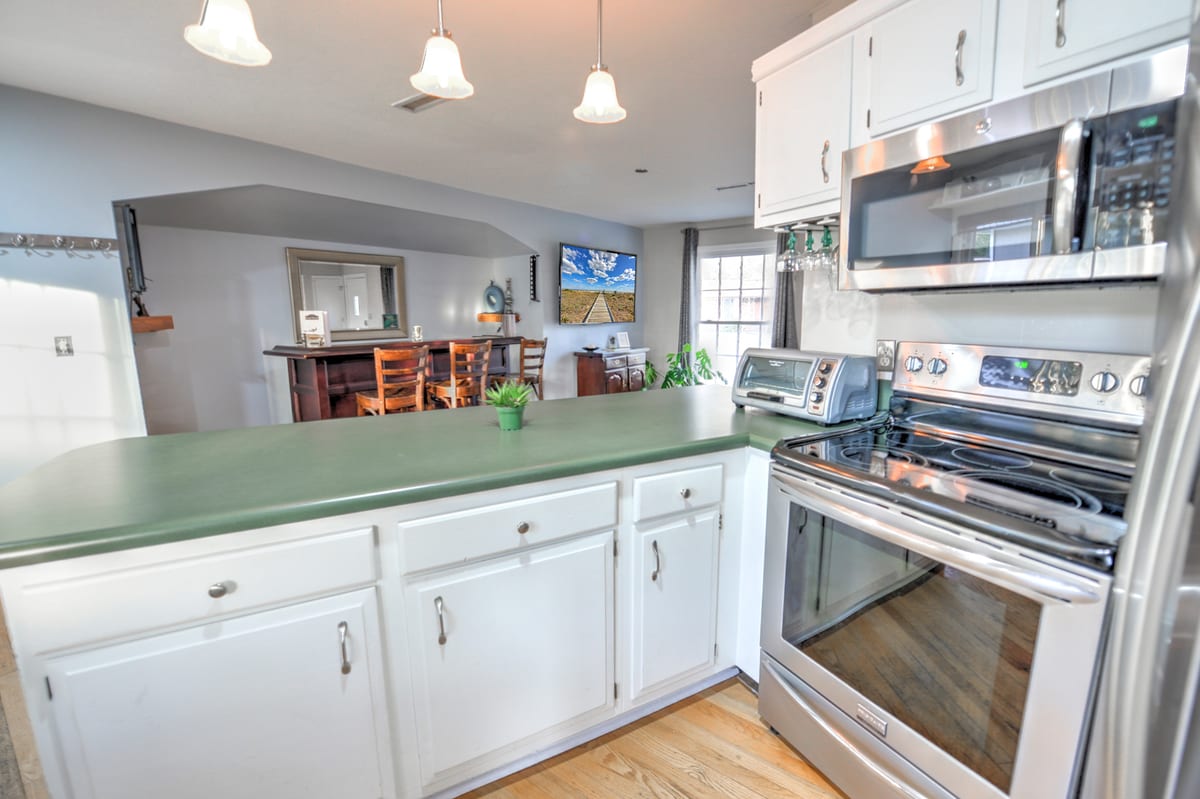 Kitchen with stainless range, microwave, and refrigerator