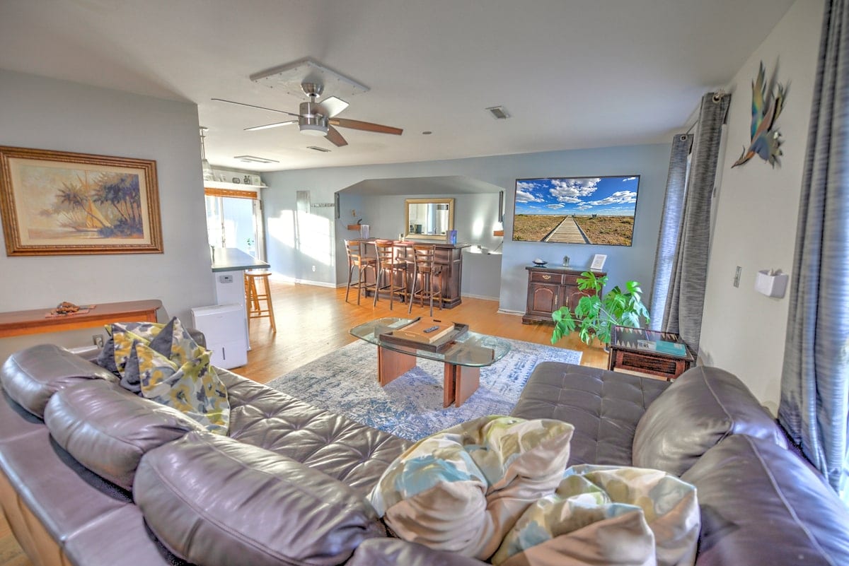 Open-plan living room with seating, television, and bar